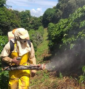 Homem realizando aplicação de produto com pulverizador costal